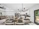 Open-concept dining room featuring a large dining table and stylish chandelier, adjacent to the living room at 5550 Mountain Trl, Snow Camp, NC 27349