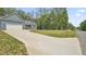 Long concrete driveway leading to a lovely blue home with a two car garage and landscaped yard at 5550 Mountain Trl, Snow Camp, NC 27349