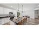 Open-concept kitchen with granite countertops, white cabinets, and a view into the dining and living areas at 5550 Mountain Trl, Snow Camp, NC 27349