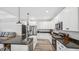 Well-lit kitchen with stainless steel appliances, dark countertops, white cabinetry, and a central island at 5550 Mountain Trl, Snow Camp, NC 27349