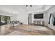 Open living area with hardwood floors, modern lighting, dining table, and entertainment center at 5550 Mountain Trl, Snow Camp, NC 27349