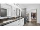 Bathroom boasts dual sinks, granite counters, and a view into the walk-in closet at 5550 Mountain Trl, Snow Camp, NC 27349