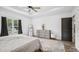 This bright main bedroom has neutral tones, a ceiling fan, and a tray ceiling at 5550 Mountain Trl, Snow Camp, NC 27349