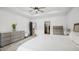 The bright main bedroom features tray ceilings, hardwood floors, and calming neutral tones at 5550 Mountain Trl, Snow Camp, NC 27349