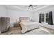 Bright main bedroom boasts a tray ceiling, neutral tones, and hardwood floors at 5550 Mountain Trl, Snow Camp, NC 27349
