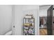 Walk-in closet featuring built in shelving and access to the en-suite bathroom at 5550 Mountain Trl, Snow Camp, NC 27349