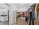 Spacious walk-in closet with custom shelving and plenty of storage for shoes and clothes at 5550 Mountain Trl, Snow Camp, NC 27349