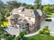 Backyard aerial view, featuring an outdoor kitchen, screened porch, and stone patio at 5768 Cavanaugh Dr, Raleigh, NC 27614