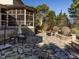 Expansive stone patio featuring an outdoor kitchen, dining area, and cozy fire pit at 5768 Cavanaugh Dr, Raleigh, NC 27614