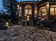 Large stone patio featuring a built-in grill, dining area, and lounge space for relaxing and entertaining guests at 5768 Cavanaugh Dr, Raleigh, NC 27614