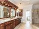 Bathroom with double sinks, glass shower, and view to toilet at 5768 Cavanaugh Dr, Raleigh, NC 27614