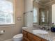 Bathroom with granite countertops and a framed mirror above the sink at 5768 Cavanaugh Dr, Raleigh, NC 27614