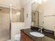 Bathroom featuring a tiled glass shower, granite vanity and chandelier lighting at 5768 Cavanaugh Dr, Raleigh, NC 27614