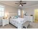 Bedroom with decorative bed and bench, ceiling fan, and windows at 5768 Cavanaugh Dr, Raleigh, NC 27614