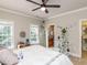 Bright bedroom featuring decor, a ceiling fan, and a peek into the en-suite bathroom at 5768 Cavanaugh Dr, Raleigh, NC 27614