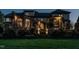 Stately home featuring a manicured lawn, brick facade, and outdoor lighting creating a welcoming ambiance at 5768 Cavanaugh Dr, Raleigh, NC 27614