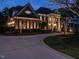 Elegant brick home featuring a grand entrance with columns, manicured lawn, and a long driveway, perfect for luxury living at 5768 Cavanaugh Dr, Raleigh, NC 27614