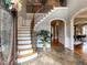 Grand foyer with marble floors, a staircase, and elegant architectural details at 5768 Cavanaugh Dr, Raleigh, NC 27614