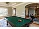 Game room with a pool table, tiled floor, and seamless access to the dining area at 5768 Cavanaugh Dr, Raleigh, NC 27614