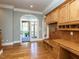 Bright hallway with hardwood floors, custom built-ins, desk space, and access to the screened in porch at 5768 Cavanaugh Dr, Raleigh, NC 27614