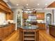 Gourmet kitchen with a large island, custom cabinetry, stainless steel appliances, and hardwood floors at 5768 Cavanaugh Dr, Raleigh, NC 27614