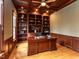 Home office with wooden coffered ceiling, built-in bookshelves, and a large wooden desk at 5768 Cavanaugh Dr, Raleigh, NC 27614