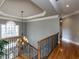 Lovely staircase with beautiful railings, hardwood floors, and decorative lighting at 5768 Cavanaugh Dr, Raleigh, NC 27614