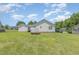 Spacious backyard view showing garage, trailer and well-maintained lawn at 6 N Carolina Ave, Benson, NC 27504
