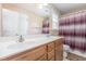 Bathroom features a double sink vanity with a large mirror and shower with curtain at 6 N Carolina Ave, Benson, NC 27504