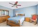 Comfortable bedroom with a ceiling fan, carpet, and wooden furniture at 6 N Carolina Ave, Benson, NC 27504