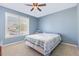 Cozy bedroom with a ceiling fan and a large window with natural light at 6 N Carolina Ave, Benson, NC 27504