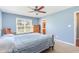 Bedroom with carpet, wood furniture, ceiling fan, and a bright window view at 6 N Carolina Ave, Benson, NC 27504