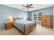 Comfortable bedroom with wood furniture, a ceiling fan, and a large window at 6 N Carolina Ave, Benson, NC 27504