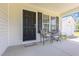 Cozy front porch featuring a table and chairs, ideal for relaxing outdoors and enjoying the view at 6 N Carolina Ave, Benson, NC 27504