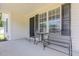 Inviting front porch area with seating, perfect for enjoying a quiet morning or evening outdoors at 6 N Carolina Ave, Benson, NC 27504