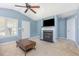 Comfortable living room with a fireplace, TV, vaulted ceiling, and neutral carpet at 6 N Carolina Ave, Benson, NC 27504