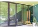 Building entrance with large glass doors, modern design, and outdoor seating at 600 S Duke St # 24, Durham, NC 27701