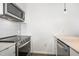 Close up of modern kitchen with stainless steel oven, microwave and white backsplash at 600 S Duke St # 24, Durham, NC 27701