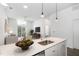 Modern kitchen with island and stainless steel appliances, with living room in the background at 600 S Duke St # 24, Durham, NC 27701