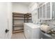Functional laundry room with washer, dryer, and storage shelves at 600 S Duke St # 24, Durham, NC 27701