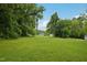 Expansive, lush green lawn with mature trees, offering a serene and picturesque setting for a residential property at 620 Mcadams Rd, Hillsborough, NC 27278