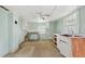 Spacious kitchen with two windows and a vintage ceiling fan at 620 Mcadams Rd, Hillsborough, NC 27278