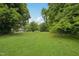 Expansive backyard with mature trees and grass at 620 Mcadams Rd, Hillsborough, NC 27278