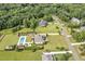 Aerial view of a spacious home with a large pool and cabana with lots of green space at 6250 Moinear Ln, Chapel Hill, NC 27514