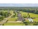 Aerial view of beautiful homes with large yards, swimming pool, neighborhood streets, and trees at 6250 Moinear Ln, Chapel Hill, NC 27514
