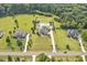 Aerial view of neighborhood featuring stately homes and vast manicured green lawns and landscaping at 6250 Moinear Ln, Chapel Hill, NC 27514