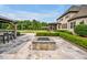 Serene backyard featuring an outdoor kitchen, fire pit, manicured lawn, and lush landscaping for outdoor living at 6250 Moinear Ln, Chapel Hill, NC 27514