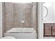 Well-lit bathroom features a bathtub with sleek tiled walls and a glass shower door at 6250 Moinear Ln, Chapel Hill, NC 27514