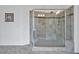Modern bathroom featuring a glass shower with tile walls and a built-in bench at 6250 Moinear Ln, Chapel Hill, NC 27514