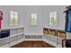Walk-in closet with custom built-ins, white shelving, and natural light from large windows at 6250 Moinear Ln, Chapel Hill, NC 27514